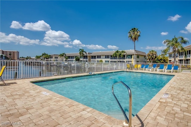 pool featuring a patio area and fence