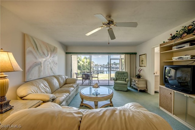 carpeted living room with ceiling fan