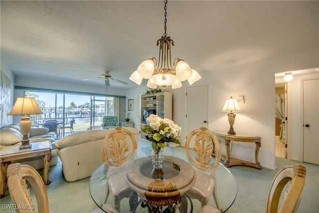 dining room with a ceiling fan and carpet flooring