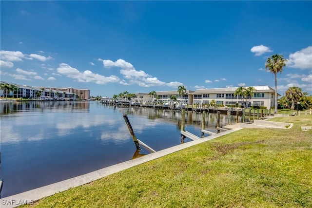 dock area featuring a lawn and a water view