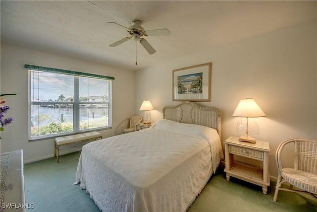 bedroom featuring baseboards, carpet, a ceiling fan, and a water view