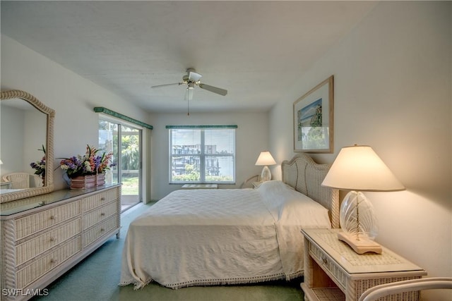 carpeted bedroom with access to exterior and a ceiling fan