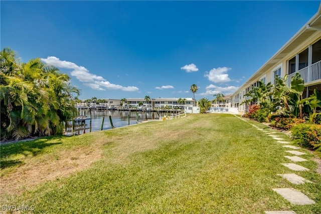 view of yard with a dock and a water view