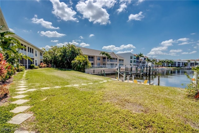 view of dock with a residential view and a yard