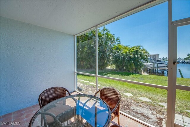 1950 Beach Pkwy Unit 103, Cape Coral, FL 33904 - sunroom / solarium featuring a water view