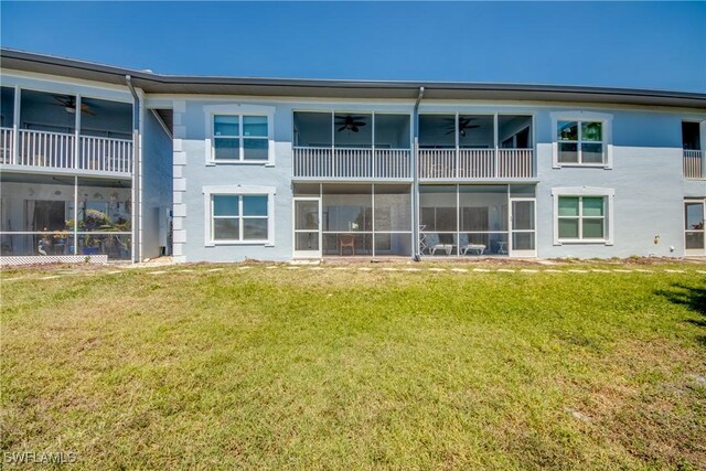 1950 Beach Pkwy Unit 103, Cape Coral, FL 33904 - rear view of house with a yard and a ceiling fan
