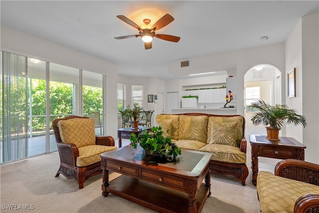 sunroom / solarium featuring visible vents, arched walkways, and ceiling fan