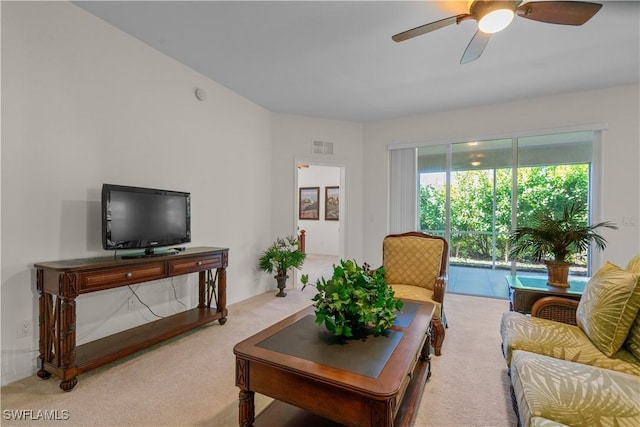 living area with carpet flooring, ceiling fan, and visible vents