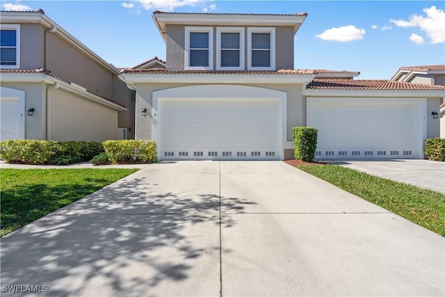 view of front of home featuring stucco siding, concrete driveway, and a tiled roof