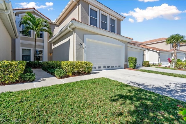 view of front of home featuring stucco siding, concrete driveway, a front yard, a garage, and a tiled roof