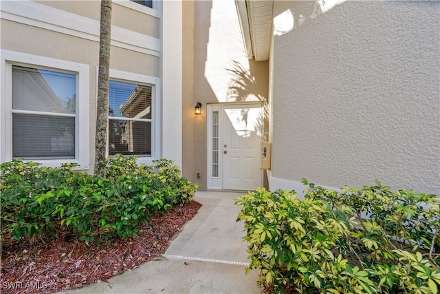 entrance to property with stucco siding