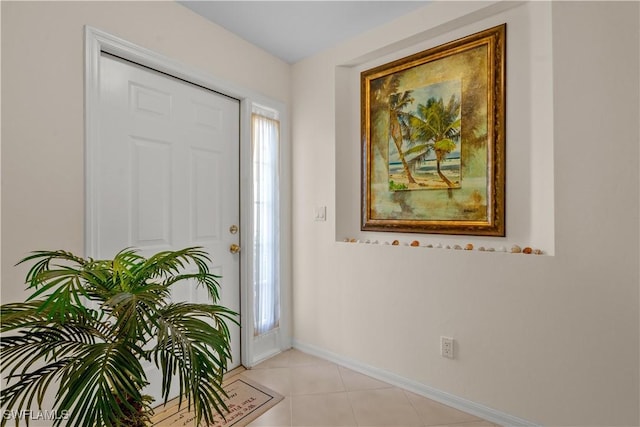 entrance foyer with light tile patterned floors and baseboards