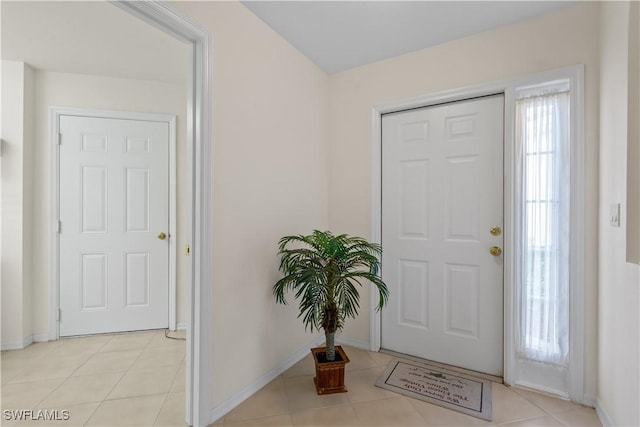 foyer entrance featuring light tile patterned floors and baseboards