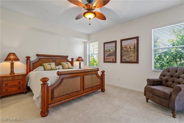 bedroom featuring baseboards, light carpet, and ceiling fan