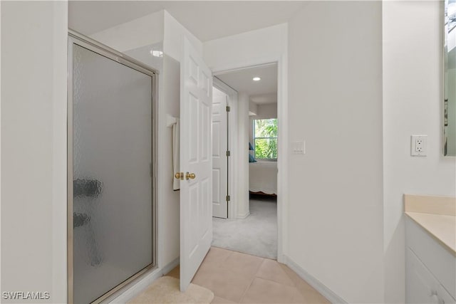 full bathroom featuring tile patterned floors, a shower stall, vanity, and connected bathroom