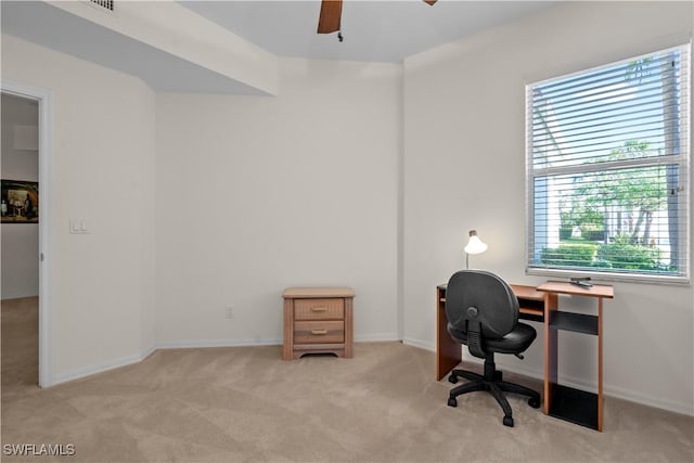 office area with baseboards, light carpet, and ceiling fan