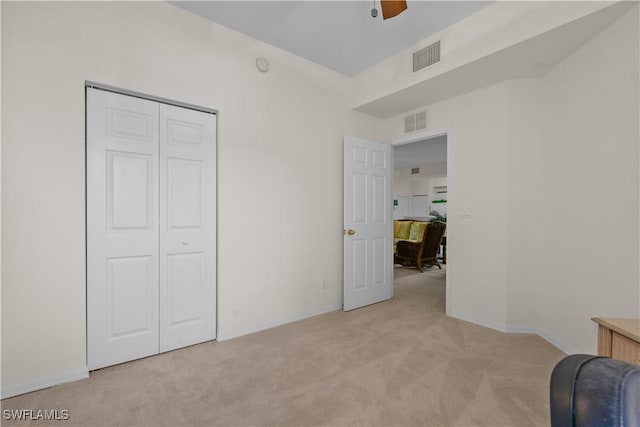 unfurnished bedroom with visible vents, baseboards, and light colored carpet