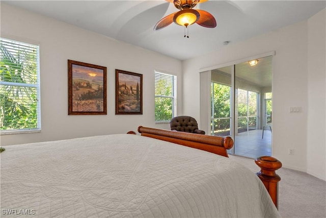 carpeted bedroom with ceiling fan and access to exterior