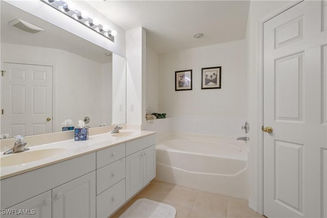 bathroom featuring tile patterned floors, a bath, visible vents, and a sink