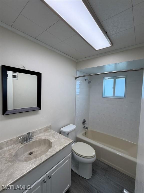 full bath with toilet, vanity,  shower combination, and wood finished floors