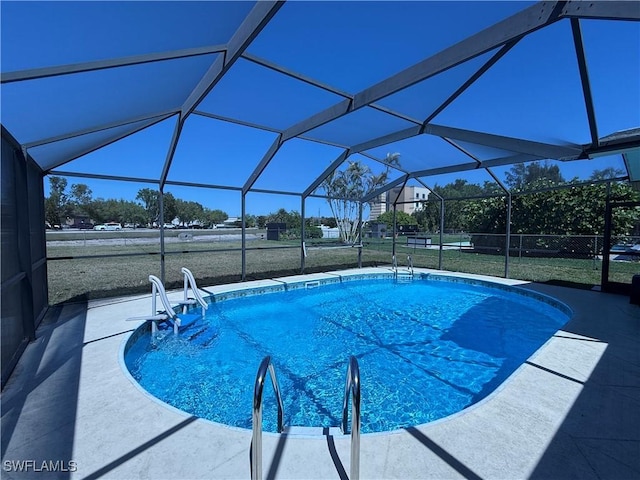 pool with a lanai, a yard, and a patio