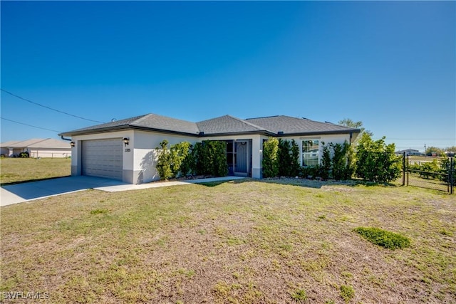 view of front facade featuring a front yard, fence, stucco siding, concrete driveway, and a garage