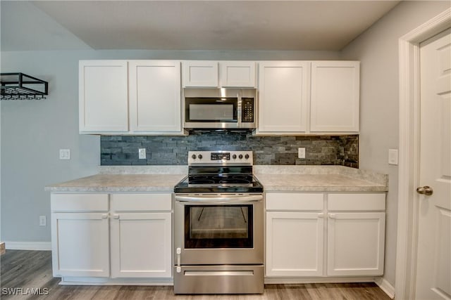 kitchen with white cabinetry, tasteful backsplash, and stainless steel appliances