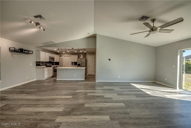 unfurnished living room with dark wood finished floors, vaulted ceiling, visible vents, and ceiling fan