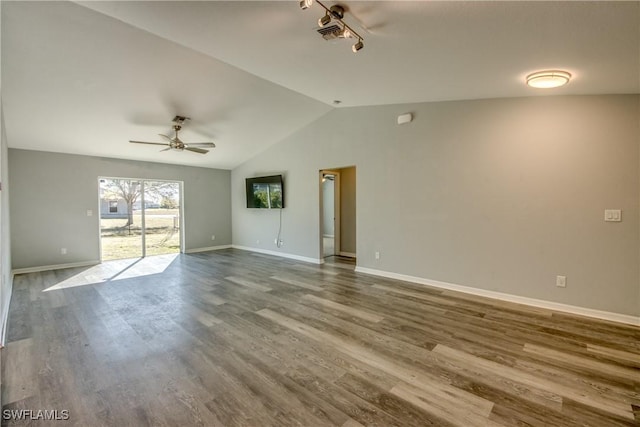 empty room featuring visible vents, ceiling fan, baseboards, lofted ceiling, and dark wood-style flooring