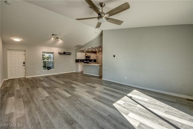 unfurnished living room featuring vaulted ceiling, ceiling fan, and wood finished floors