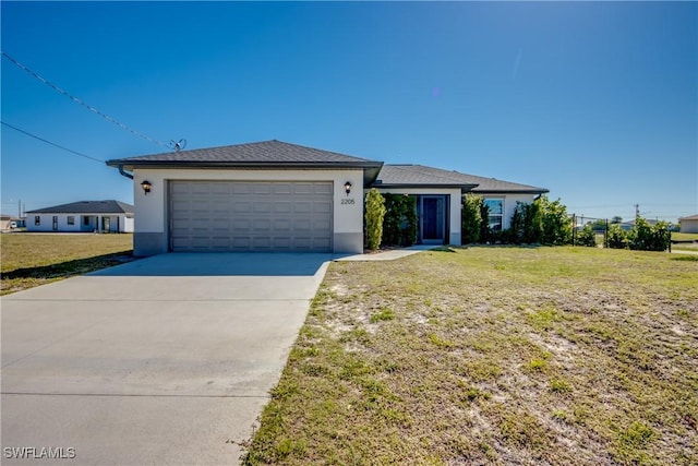 view of front of home with a garage, driveway, a front yard, and stucco siding