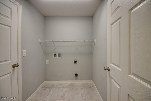 laundry area with laundry area, hookup for a washing machine, electric dryer hookup, and baseboards