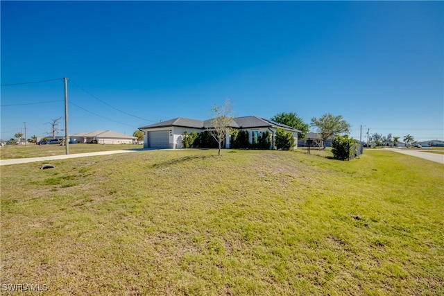 ranch-style house featuring a front lawn and a garage