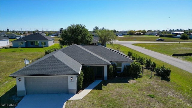 ranch-style house featuring concrete driveway, fence, a garage, and stucco siding