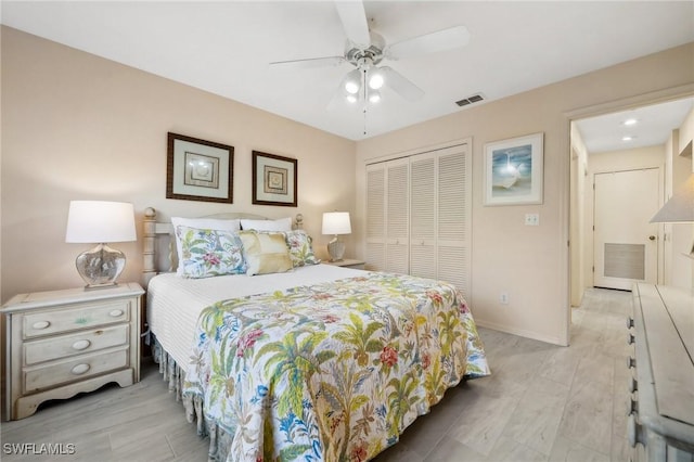 bedroom featuring a closet, visible vents, and light wood-type flooring