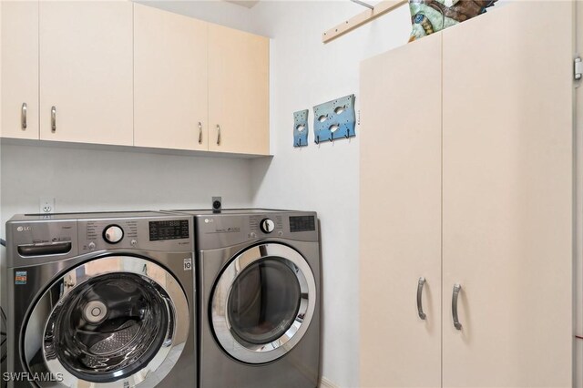 laundry room with cabinet space and separate washer and dryer