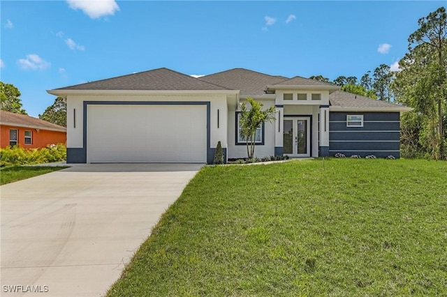 prairie-style house with a front lawn, an attached garage, french doors, and stucco siding