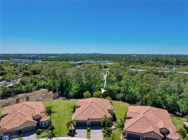 birds eye view of property with a forest view