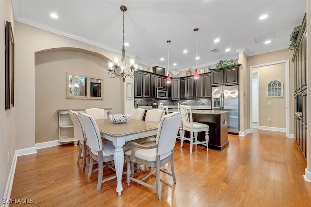 dining room featuring baseboards, recessed lighting, ornamental molding, light wood-style floors, and a chandelier