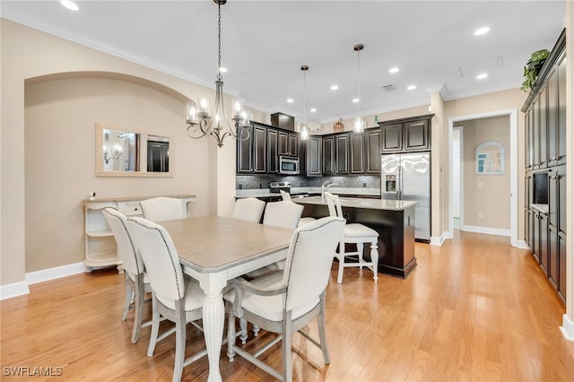9149 Isla Bella Cir, Bonita Springs, FL 34135 - dining room with crown molding, a chandelier, baseboards, recessed lighting, and light wood finished floors