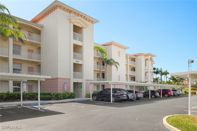 4017 Palm Tree Blvd Unit 308, Cape Coral, FL 33904 - view of building exterior featuring covered and uncovered parking