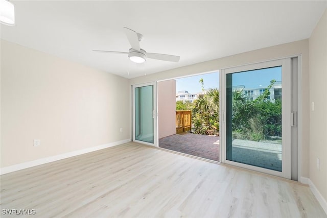 200 Periwinkle Way Unit 132, Sanibel, FL 33957 - empty room featuring a ceiling fan, baseboards, and wood finished floors