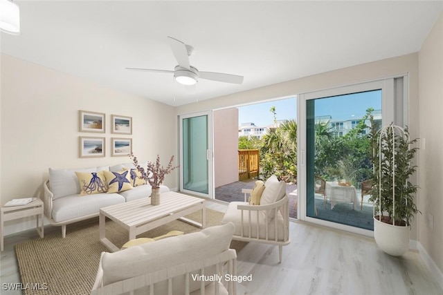 200 Periwinkle Way Unit 132, Sanibel, FL 33957 - living area featuring baseboards, wood finished floors, and ceiling fan