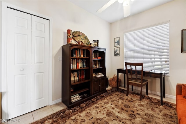 home office featuring tile patterned floors, baseboards, and ceiling fan