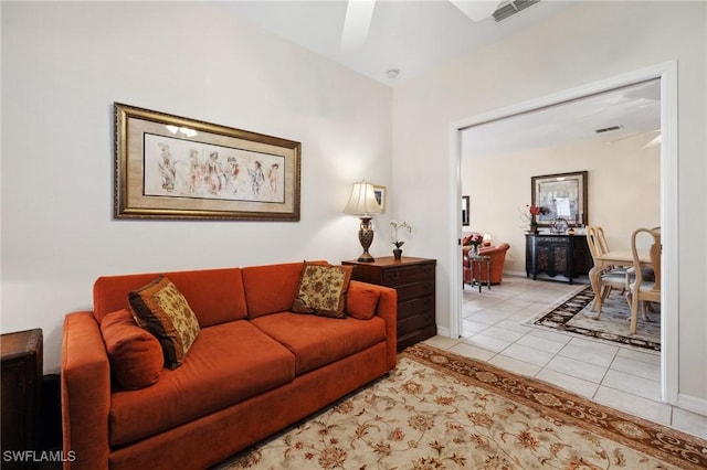 living room featuring light tile patterned floors, baseboards, and visible vents