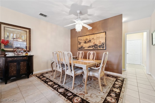 dining area featuring light tile patterned floors, baseboards, visible vents, and ceiling fan