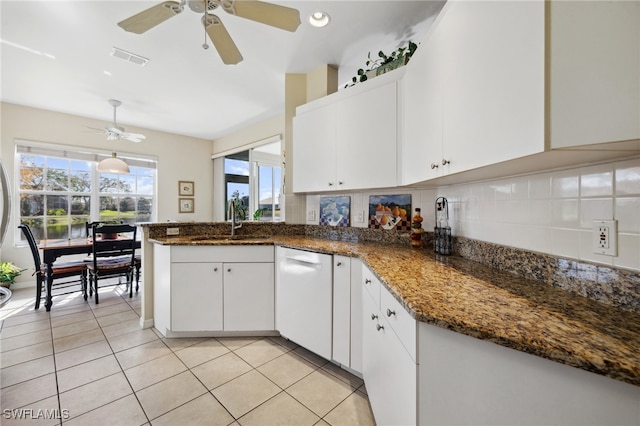 kitchen featuring a sink, tasteful backsplash, ceiling fan, and white dishwasher