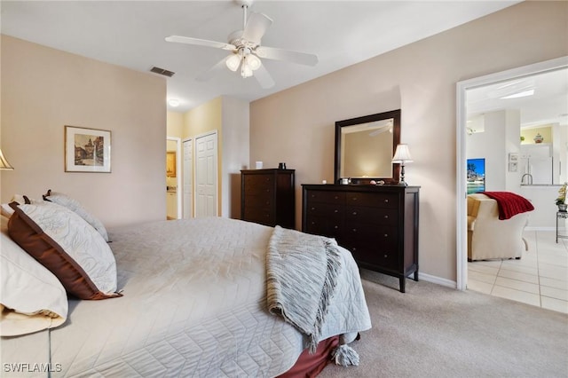 tiled bedroom featuring visible vents, a ceiling fan, connected bathroom, carpet floors, and baseboards