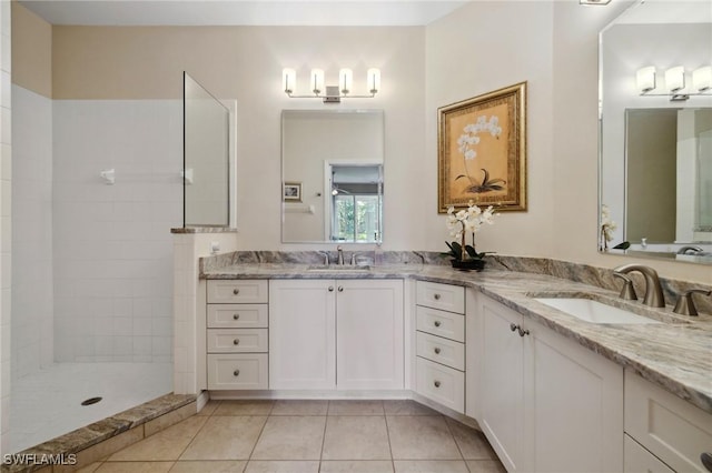 bathroom featuring a sink, walk in shower, double vanity, and tile patterned flooring