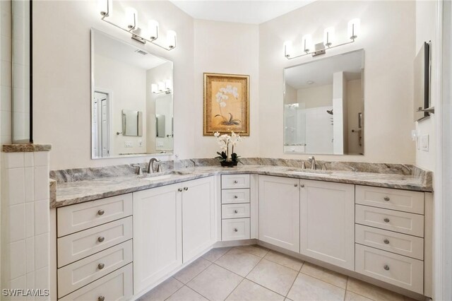 14571 Glen Cove Dr Unit 1001, Fort Myers, FL 33919 - bathroom featuring tile patterned floors, double vanity, and a sink